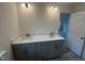 Bathroom featuring a double sink vanity with quartz countertops, gray cabinets, and modern fixtures at 766 Old Station Pointe, Angier, NC 27501