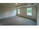 Spacious bedroom with two windows providing natural light, plush carpeting and a tray ceiling at 766 Old Station Pointe, Angier, NC 27501