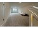 A spacious bonus room with neutral carpet and ample natural light from the window, ready for customization at 766 Old Station Pointe, Angier, NC 27501