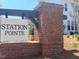 Welcome to Station Pointe, brick signage. Community features mature landscaping and inviting entry at 766 Old Station Pointe, Angier, NC 27501