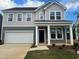Charming two-story home featuring a two-car garage and well-manicured lawn at 766 Old Station Pointe, Angier, NC 27501