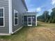 Side exterior view of home with screened-in porch and manicured lawn at 766 Old Station Pointe, Angier, NC 27501