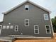 Side view of the new construction home featuring gray siding and white trim, accentuating its modern aesthetic at 766 Old Station Pointe, Angier, NC 27501