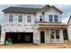 New two-story home under construction features an attached garage and a covered front porch at 766 Old Station Pointe, Angier, NC 27501