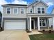 Inviting two-story home boasts a two-car garage and classic architectural details at 766 Old Station Pointe, Angier, NC 27501