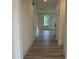 Bright hallway featuring hardwood floors, white trim, and ample natural light at 766 Old Station Pointe, Angier, NC 27501