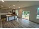 Spacious kitchen features stainless appliances, gray cabinets, and a large island perfect for entertaining at 766 Old Station Pointe, Angier, NC 27501