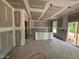 Open kitchen with an island, sliding glass doors, and plenty of natural light, under construction at 766 Old Station Pointe, Angier, NC 27501