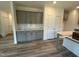 This gourmet kitchen features gray cabinets, modern backsplash, quartz countertops, and stainless appliances at 766 Old Station Pointe, Angier, NC 27501