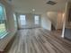 A spacious living room with lots of light, wood floors, and stairs leading to the second floor at 766 Old Station Pointe, Angier, NC 27501