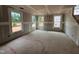 Bright living room with three windows offering natural light and a view, under construction at 766 Old Station Pointe, Angier, NC 27501