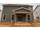 Covered patio view with grey siding and white trim, providing a perfect spot for outdoor relaxation at 766 Old Station Pointe, Angier, NC 27501