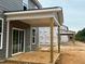 Side view of the covered patio offering a glimpse into the new construction community's outdoor living spaces at 766 Old Station Pointe, Angier, NC 27501