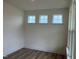 Bright room with hardwood floors and three windows letting in ample sunlight at 766 Old Station Pointe, Angier, NC 27501