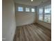 Sunlit room with hardwood floors and three windows offering neighborhood views at 766 Old Station Pointe, Angier, NC 27501