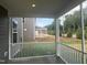 View from the screened porch showing an expansive yard with sprinkler and another structure nearby at 766 Old Station Pointe, Angier, NC 27501