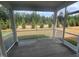 Inviting screened-in porch providing a serene view of the home's well-maintained green surroundings at 766 Old Station Pointe, Angier, NC 27501