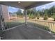 Relaxing screened porch featuring white railings and views of the landscaped backyard and sprinkler system at 766 Old Station Pointe, Angier, NC 27501