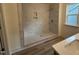 Modern bathroom showcasing a tiled walk-in shower, a window for natural light, and stylish fixtures at 766 Old Station Pointe, Angier, NC 27501