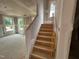 Staircase under construction with wood stairs and natural light at 766 Old Station Pointe, Angier, NC 27501