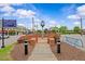 Picturesque view of the town square with a clock and beautifully landscaped flowerbeds, perfect for community events at 766 Old Station Pointe, Angier, NC 27501