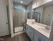 Contemporary bathroom showcasing a glass shower, double vanity with sleek countertops and modern mirrors at 771 Old Station Pointe, Angier, NC 27501