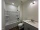 Well-lit bathroom showcasing a modern vanity, toilet, and a shower-tub combination at 771 Old Station Pointe, Angier, NC 27501