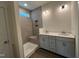 Bathroom featuring a glass-enclosed shower, dual vanity, and modern fixtures at 771 Old Station Pointe, Angier, NC 27501