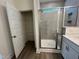 Modern bathroom featuring a glass-enclosed shower, grey tile, and a storage closet at 771 Old Station Pointe, Angier, NC 27501