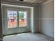 Unfinished bedroom featuring two windows and drywall ready for customization at 771 Old Station Pointe, Angier, NC 27501