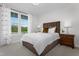 Comfortable bedroom featuring neutral carpeting, natural light, and a decorative window treatment at 771 Old Station Pointe, Angier, NC 27501