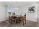 Bright dining area with contemporary light fixture, wood flooring, large windows, and access to the outdoors at 771 Old Station Pointe, Angier, NC 27501