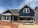 A charming, newly-built two-story home featuring a dark blue exterior with white trim and an attached two-car garage at 771 Old Station Pointe, Angier, NC 27501