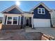 Charming new construction home with a blue exterior, brick foundation, and a two car garage at 771 Old Station Pointe, Angier, NC 27501
