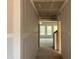 Unfinished hallway featuring white drywall, leading to a room with bright windows at 771 Old Station Pointe, Angier, NC 27501