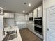 Modern kitchen with white cabinets, stainless steel appliances, and quartz countertops with tile backsplash at 771 Old Station Pointe, Angier, NC 27501