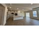 Open-concept kitchen featuring modern appliances, a center island with bar seating, and hardwood floors at 771 Old Station Pointe, Angier, NC 27501