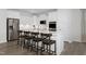 Bright kitchen with a large center island, stainless appliances, white cabinetry, and bar stool seating at 771 Old Station Pointe, Angier, NC 27501