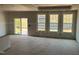 Bright living room with sliding door and large windows, ready for customization at 771 Old Station Pointe, Angier, NC 27501