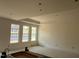 Living room with large windows and tray ceiling for ample natural light at 771 Old Station Pointe, Angier, NC 27501