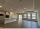 Spacious open-concept kitchen and living space with recessed lighting and hardwood floors at 771 Old Station Pointe, Angier, NC 27501