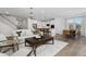 Open concept living space featuring the kitchen, dining room, living room, and staircase at 771 Old Station Pointe, Angier, NC 27501