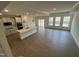 Open kitchen, dining and living space with hardwood floors and recessed lighting at 771 Old Station Pointe, Angier, NC 27501