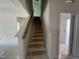 Staircase with neutral walls leading to the upper level of the home at 771 Old Station Pointe, Angier, NC 27501