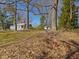 Spacious backyard featuring mature trees and a detached garage near charming light blue home at 774 Cornelius St, Hillsborough, NC 27278