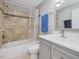 Bathroom with grey vanity, tile surround shower over tub and chrome fixtures at 774 Cornelius St, Hillsborough, NC 27278