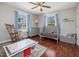Bedroom with ceiling fan, wood floors and two windows at 774 Cornelius St, Hillsborough, NC 27278