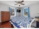 Bedroom with hardwood floors, ceiling fan, two windows and furniture at 774 Cornelius St, Hillsborough, NC 27278