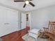Bedroom with wood floor, large closet and rocking chair at 774 Cornelius St, Hillsborough, NC 27278