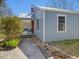 Side of a quaint blue home, highlighting the covered porch with outdoor seating at 774 Cornelius St, Hillsborough, NC 27278